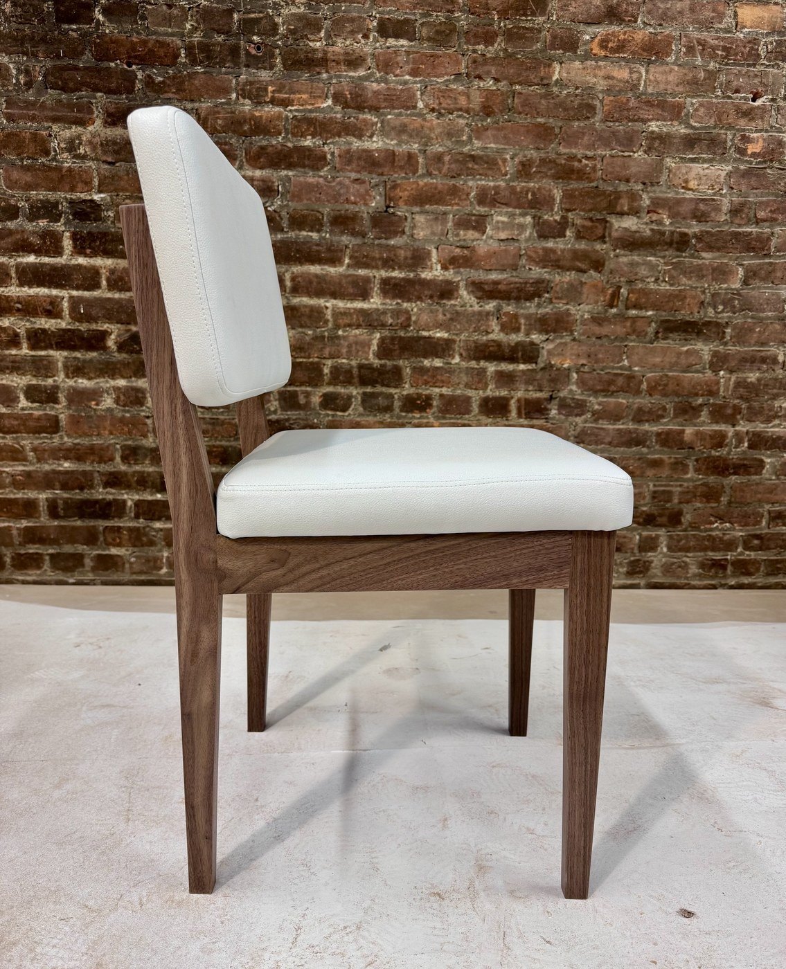 Walnut side chair with a white leather seat and back