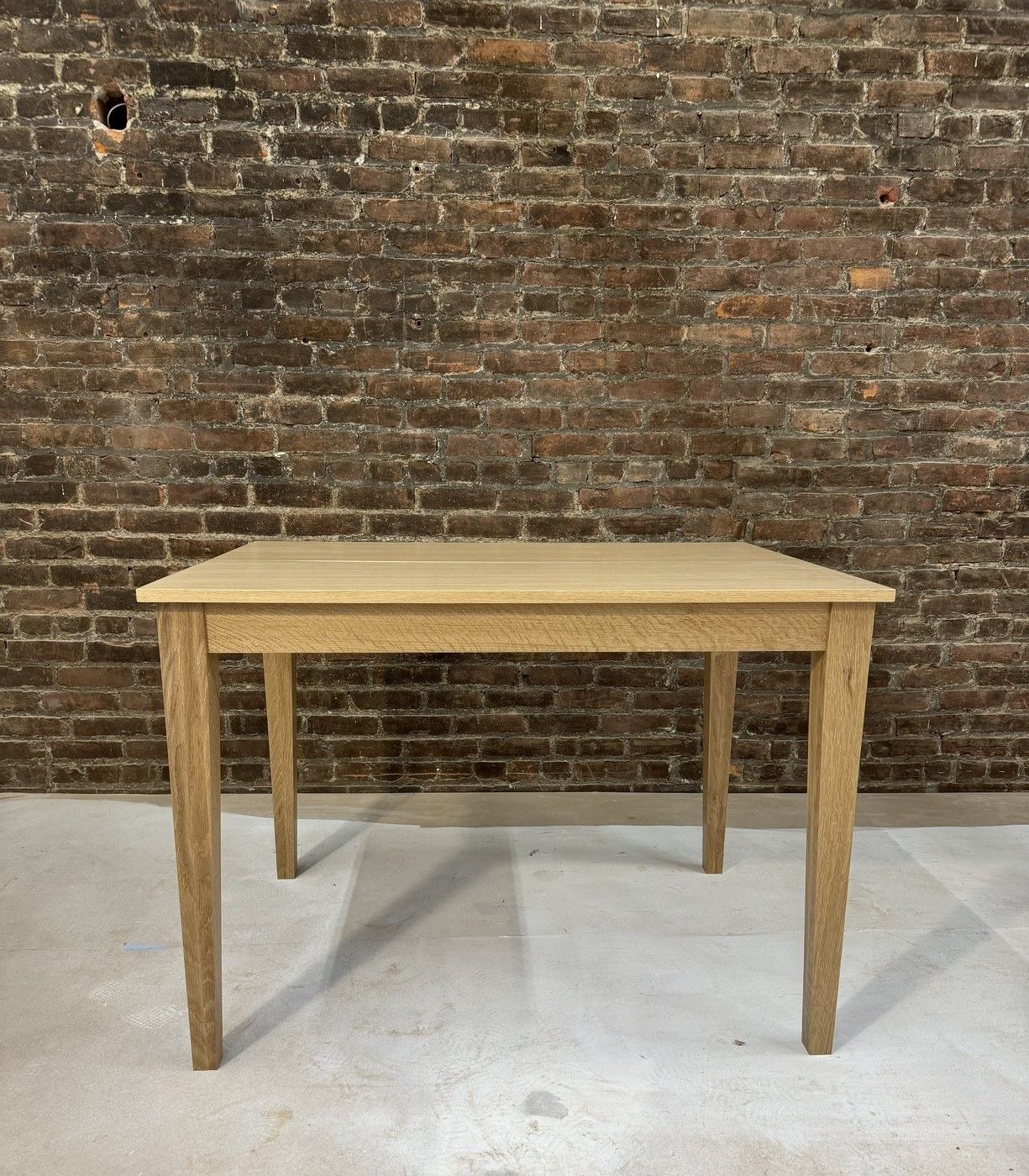 Solid white oak dining table with tapered legs