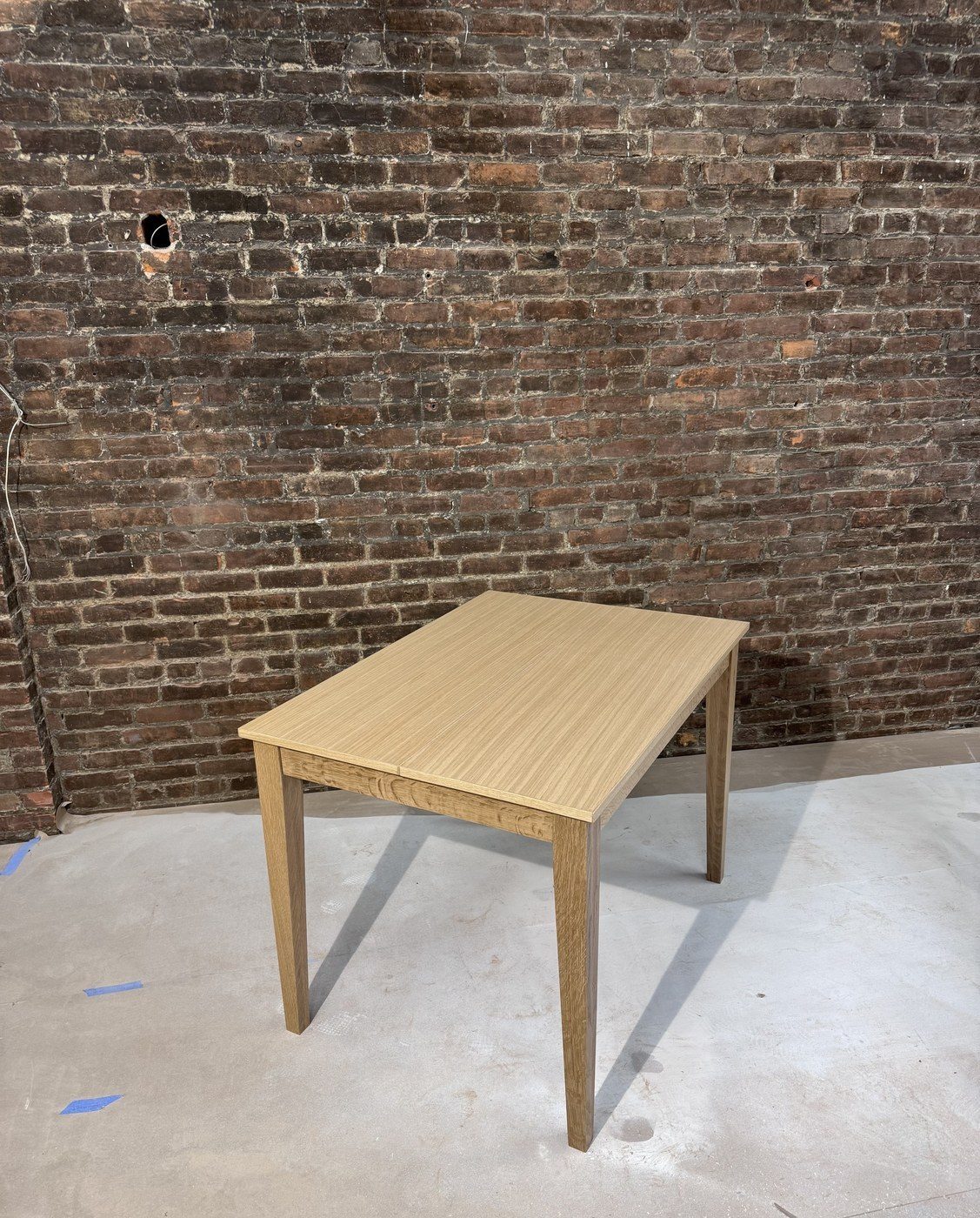 Oak table showing hand-tapered legs